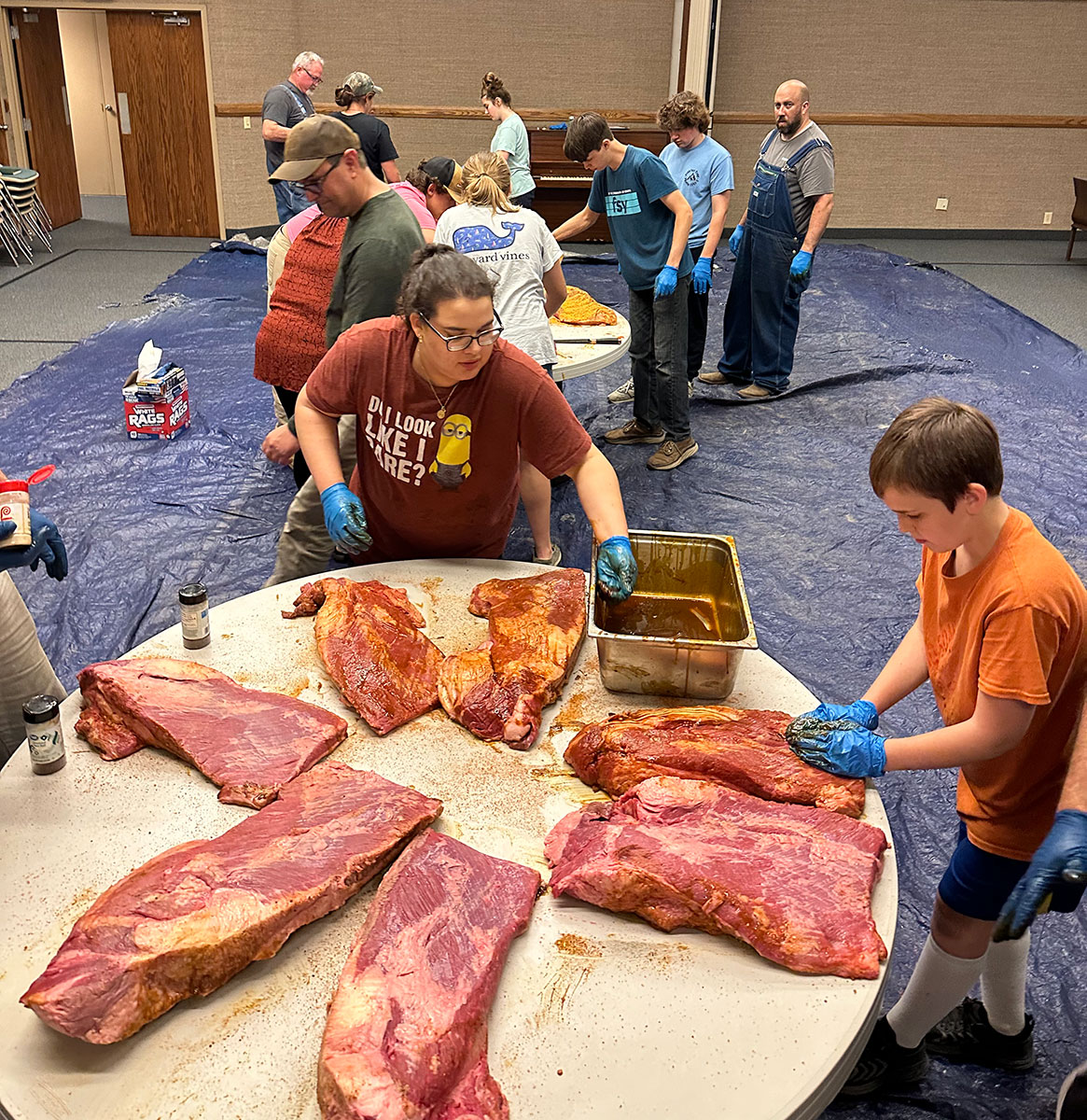 Seasoned briskets being prepared before the smoke
